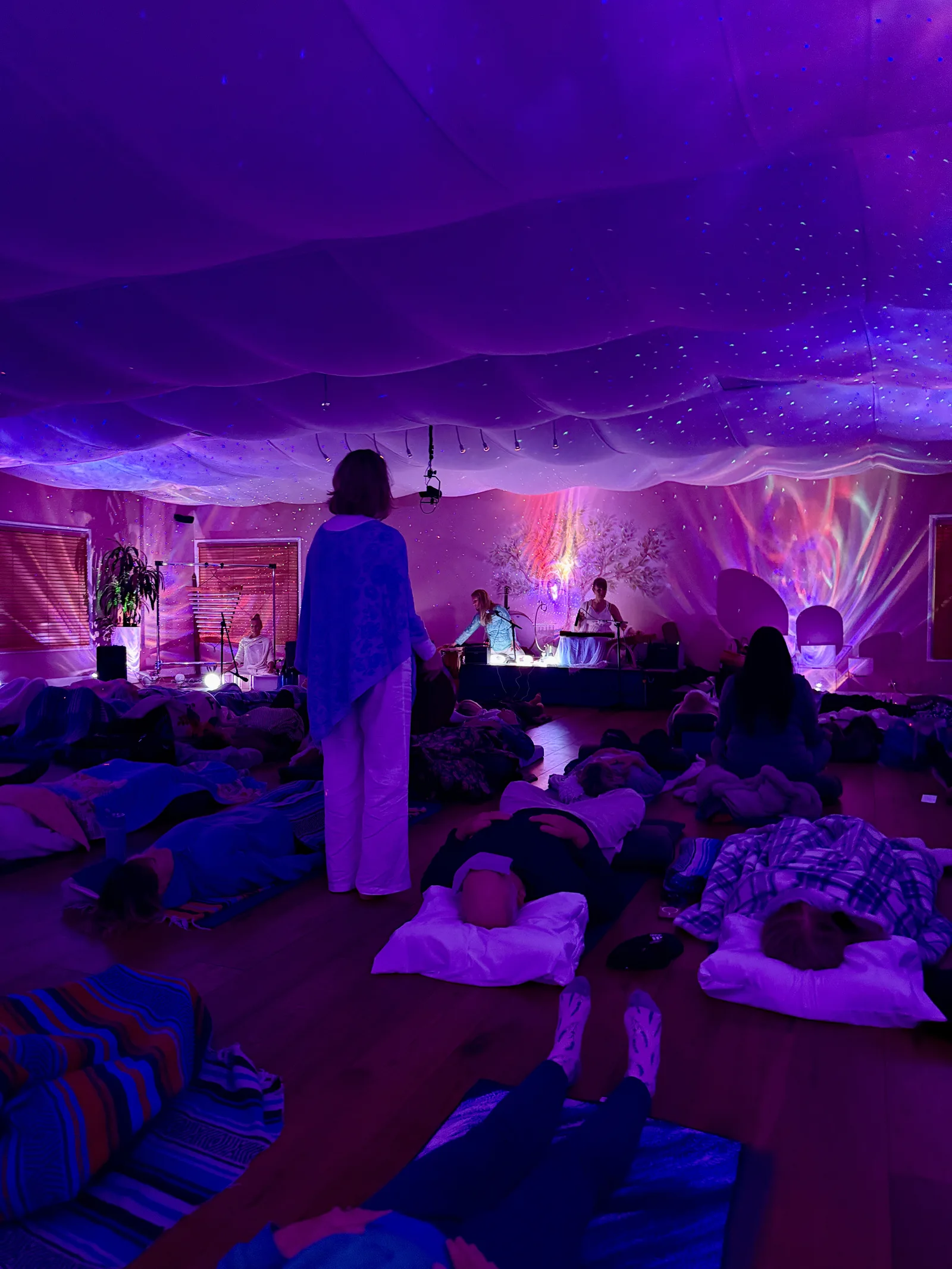 A real mobile installation: guests resting under projected stars inside a tented gathering