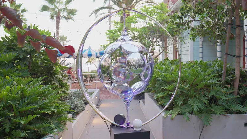 A mirrored art installation in a garden walkway at Mission Pacific Hotel by day