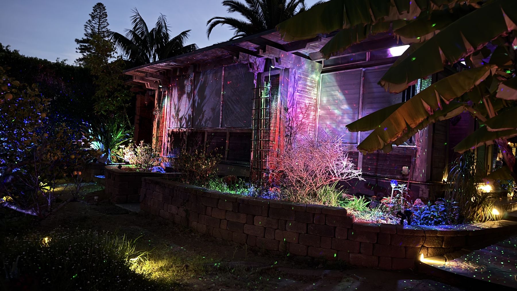 A Southern California home under a starfield projection at night